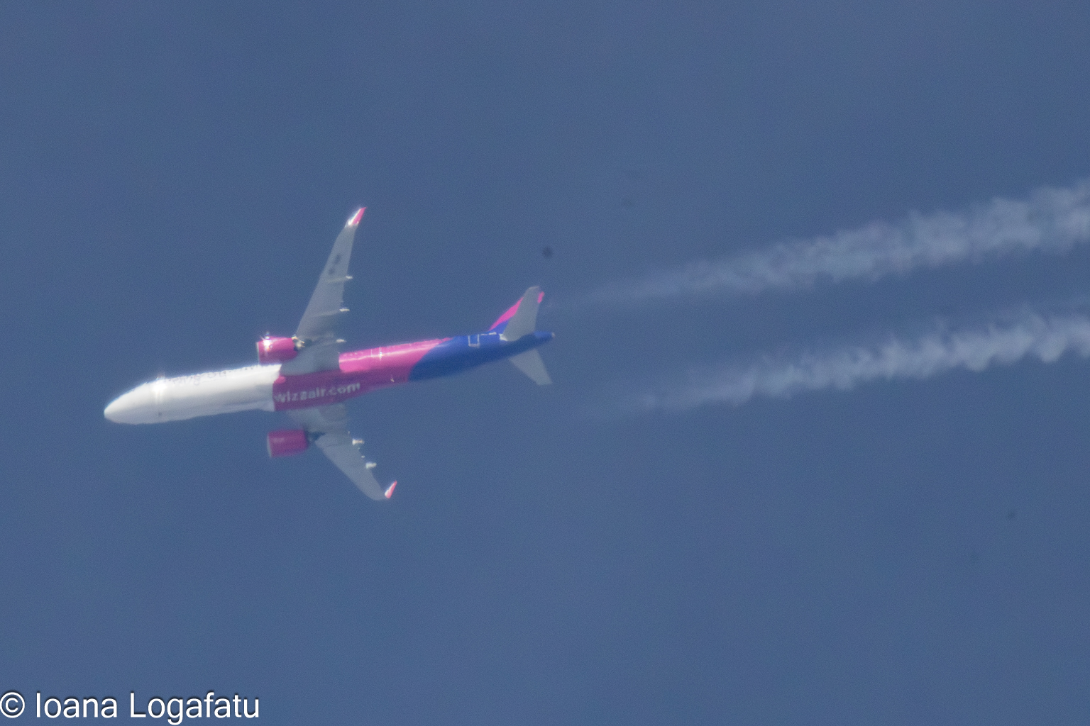 Plane flying high with contrails